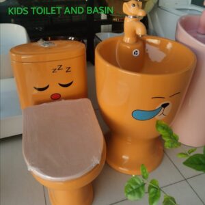 "small-size-kids-wc-in-orange-colour-with-cartoon-images"